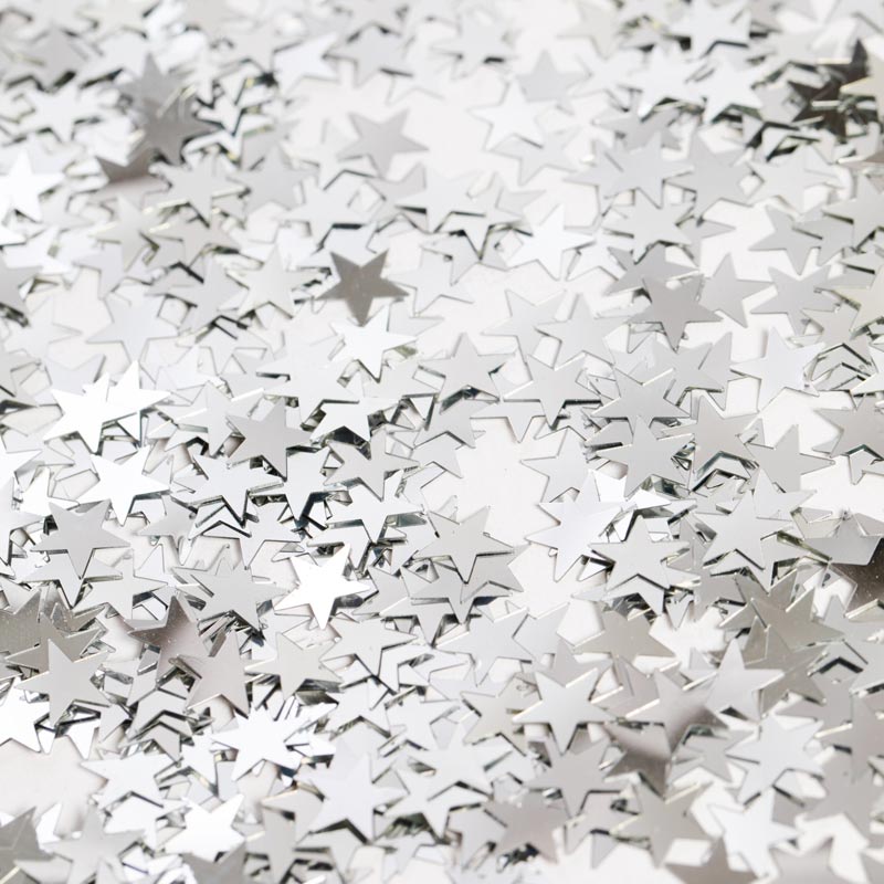 Konfetti sølvstjerner i folie til strø på bordet